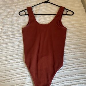 skin tight red color ribbed body suit makes you look so snatched